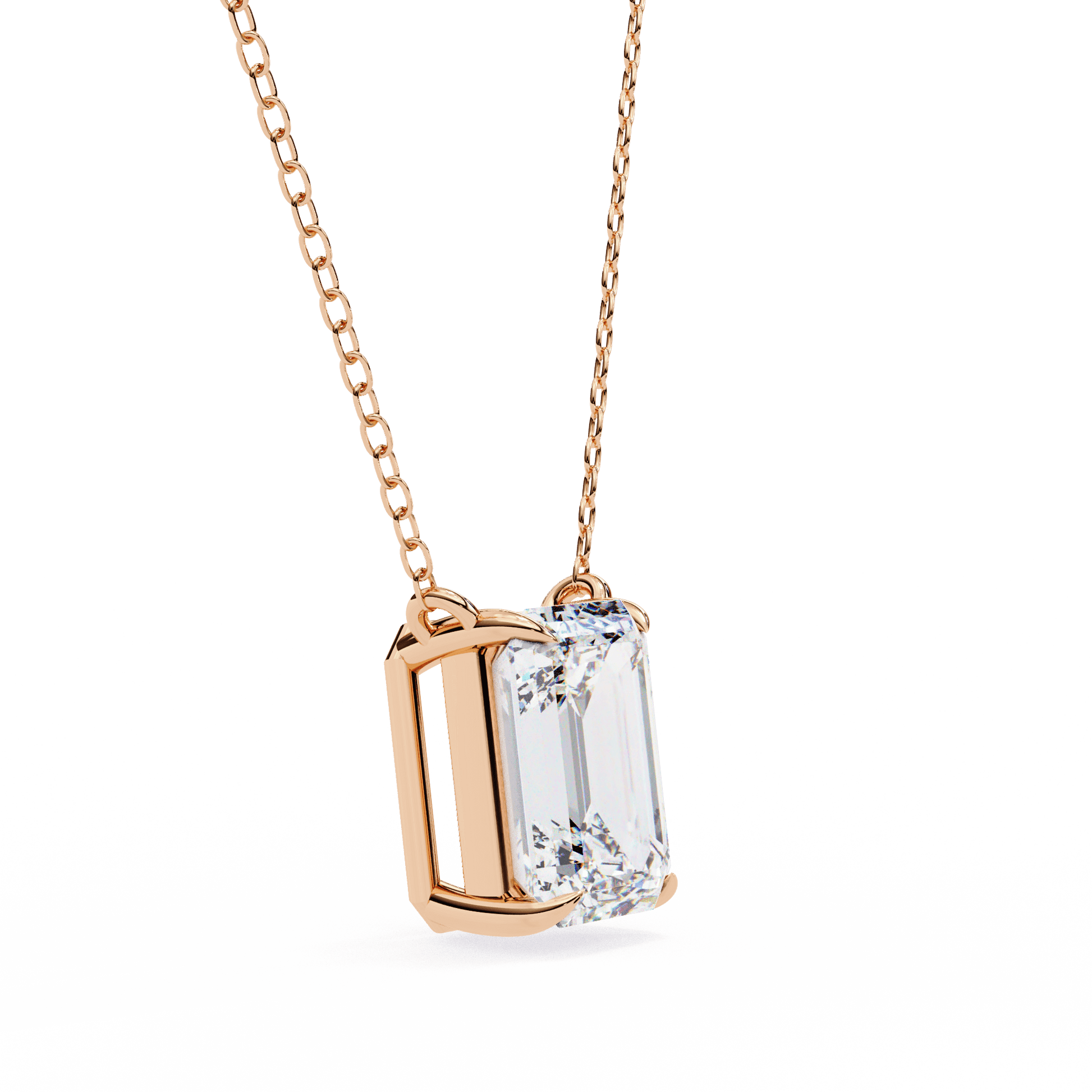 Emerald-cut solitaire pendant by Carat House Dubai featuring a sparkling green gemstone on a delicate chain.